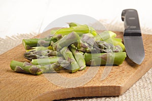 Cut Ã¢â¬â¹Ã¢â¬â¹green asparagus on a wooden board